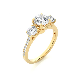 Angled view of 2.50 Carat Round Moissanite Three Stone Engagement Ring in Yellow Gold, showcasing the band and setting.