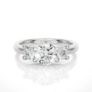 Front view of 2 Carat Round Moissanite Three Stone Engagement Ring In White Gold, highlighting the brilliant center moissanite stone.