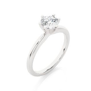 Angled view of 1.50 Carat Round Cut Moissanite Solitaire Engagement Ring In White Gold, showcasing the band and setting.