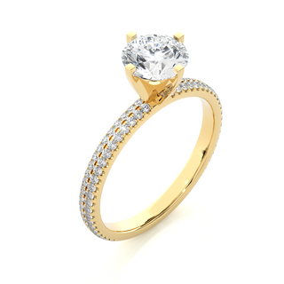 Angled view of 1.50 Ct Moissanite Engagement Ring With Accents In Yellow Gold, showcasing the band and setting.