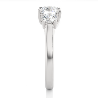 Side profile of 1.50 Ct Round Moissanite Three Stone Engagement Ring in White Gold, highlighting the brilliant center moissanite stone., highlighting the prong setting.