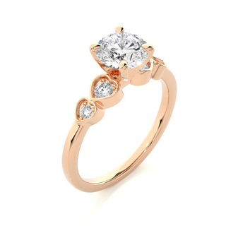 Angled view of 1.50 Ct Round Shape Moissanite Five Stone Engagement Ring In Rose Gold, showcasing the band and setting.