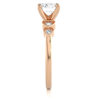 Side profile of Front view of 1.50 Ct Round Shape Moissanite Five Stone Engagement Ring In Rose Gold, highlighting the brilliant center moissanite stone., highlighting the prong setting.