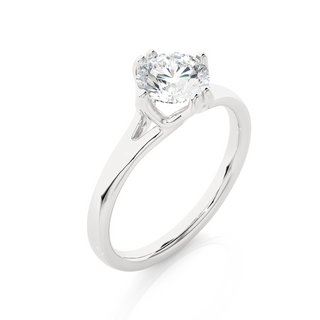 Angled view of 1 Ct Round Moissanite Solitaire Engagement Ring In White Gold, showcasing the band and setting.