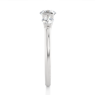 Side profile of 2 Carat Round Cut Moissanite Three Stone Engagement Ring In White Gold, highlighting the brilliant center moissanite stone., highlighting the prong setting.