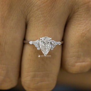 1 Carat Pear Shaped Moissanite Cluster Ring on a finger