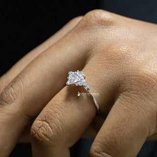 1 Carat Pear Shaped Moissanite Cluster Ring side view in lady hand