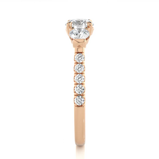 Side profile of 2 Carat Round Moissanite Engagement Three Stone Ring In Rose Gold, highlighting the prong setting.