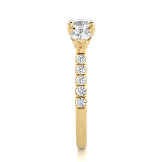 Side profile of 2 Carat Round Moissanite Engagement Three Stone Ring In Yellow Gold, highlighting the prong setting.