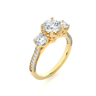 Angled view of 2 Carat Round Moissanite Filigree Three Stone Engagement Ring in Yellow Gold, showcasing the band and setting.​