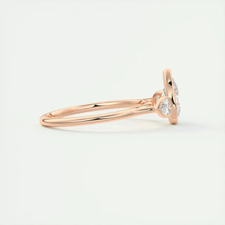 2 Carat Pear Cut Three Stone Bezel Set Moissanite Ring in Rose Gold