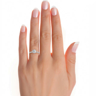 White gold hidden halo cathedral moissanite engagement ring on hand, highlighting its sparkle and elegant design.