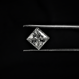 Front view of a dazzling Princess cut Moissanite held by tweezers, featuring sharp corners and brilliant faceting.